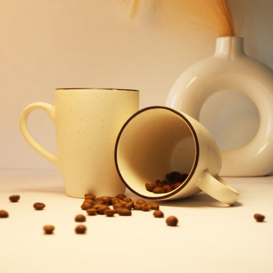 Classic Cream Ceramic Mugs with Dark Rim Accent.